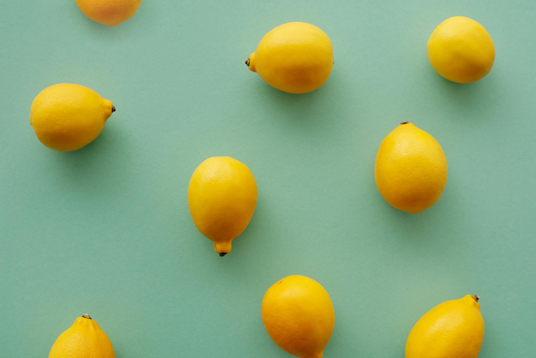 Bright yellow lemons arranged on a pastel background, symbolizing fresh starts and renewed pleasure