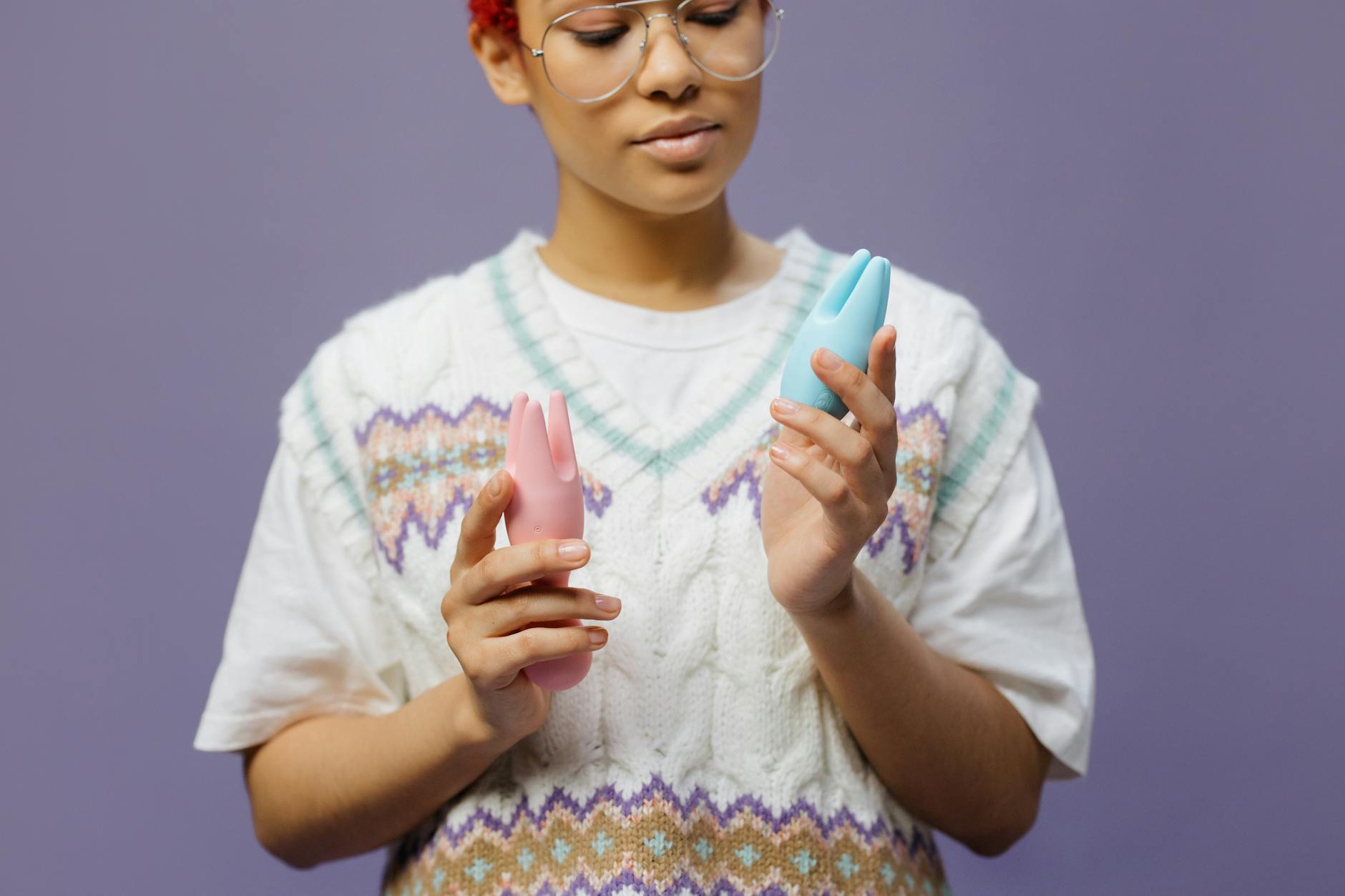 Woman contemplating holding lemon adult toys and considering intimate reconnection with partner.